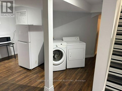 A white washing machine and dryer in a laundry room.