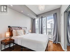 A bedroom with a large bed and a view of the outside.