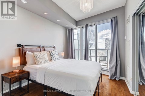 A bedroom with a large bed and a view of the outside.