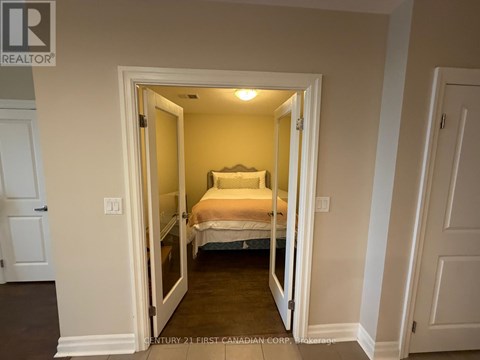A bedroom with a bed in the middle of the room.