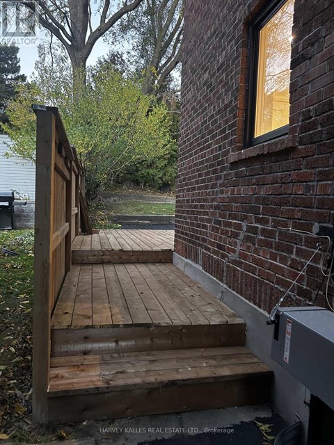 A wooden staircase leads to a brick building.
