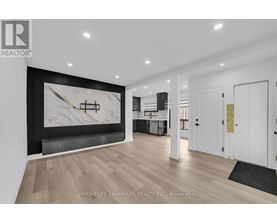 A modern living room with a large marble wall art and wooden flooring.