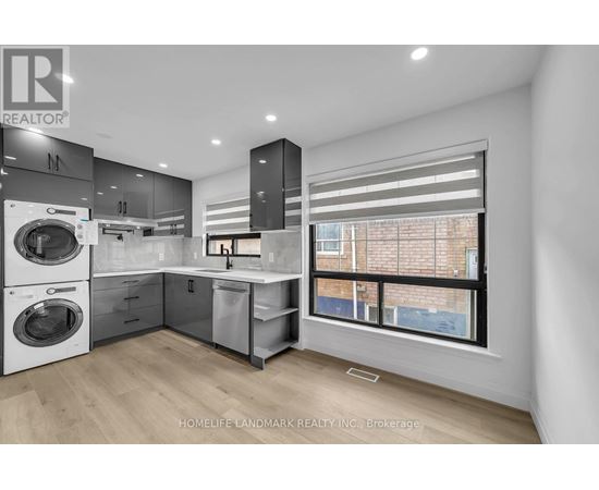 A modern kitchen with a washing machine and a window.
