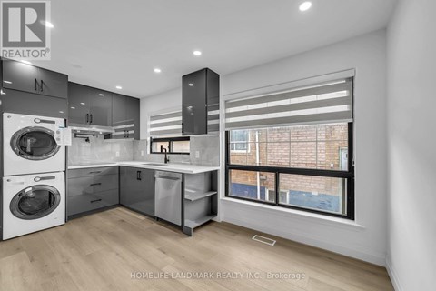 A modern kitchen with a washing machine and a window.