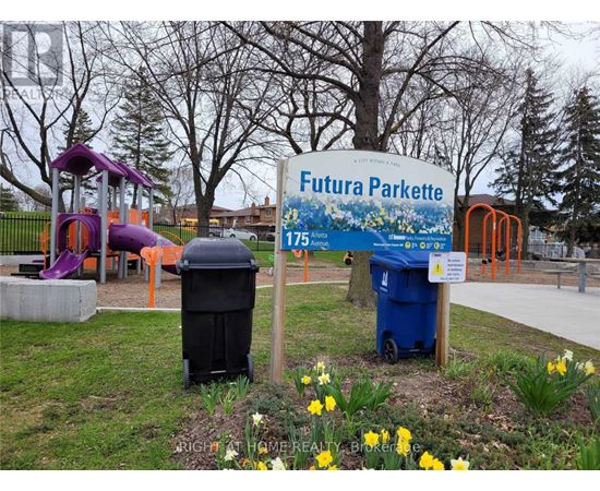 A sign for Futura Parkette is in front of a playground.