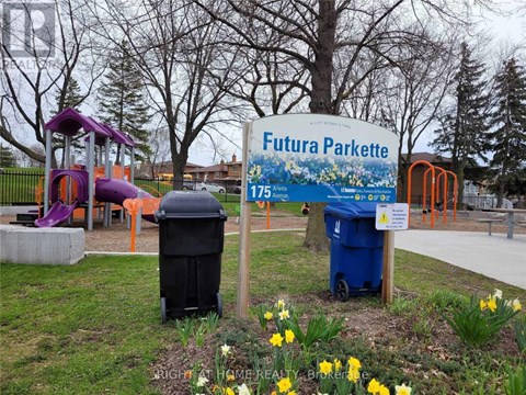 A sign for Futura Parkette is in front of a playground.