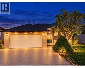 A house with a garage is shown at night.