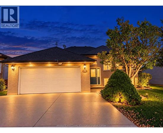 A house with a garage is shown at night.