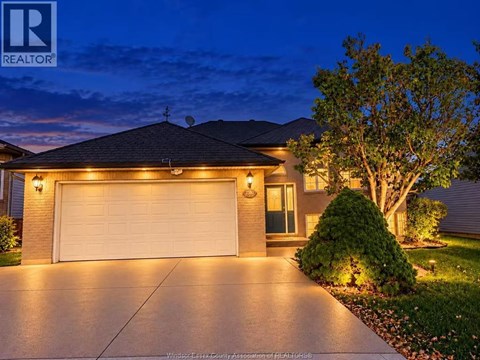 A house with a garage is shown at night.
