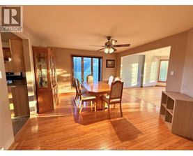 A dining room with a wooden table and chairs.