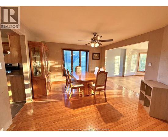 A dining room with a wooden table and chairs.