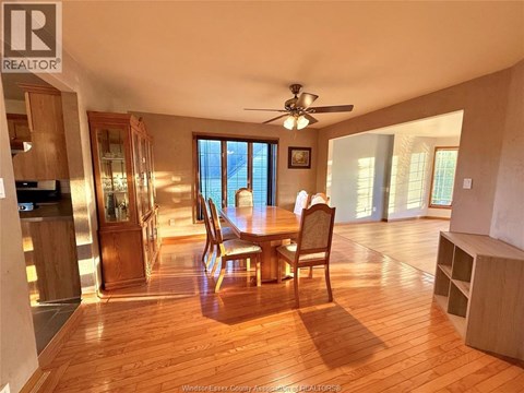 A dining room with a wooden table and chairs.