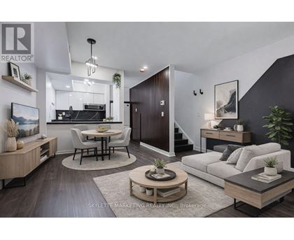 A modern living room with a kitchen area in the background.
