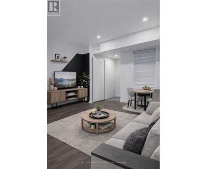 A modern living room with a grey sofa and a wooden coffee table.