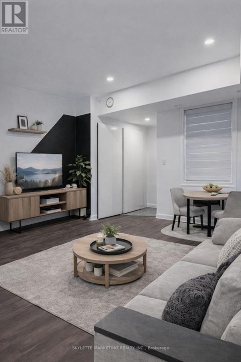 A modern living room with a grey sofa and a wooden coffee table.
