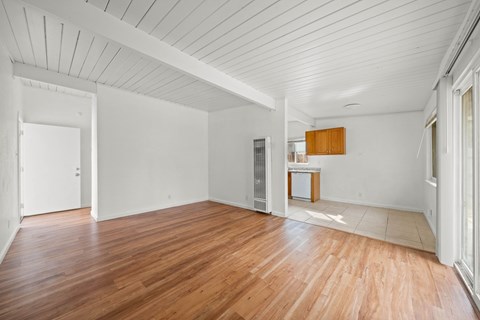 A room with wooden floors and white walls.
