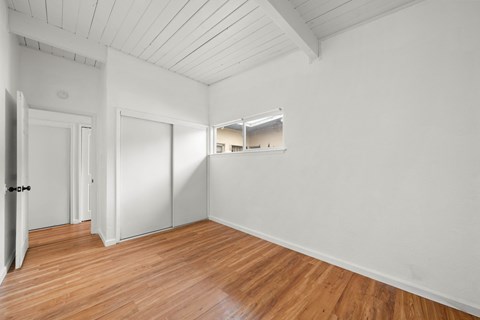 A room with wooden floors and white walls.