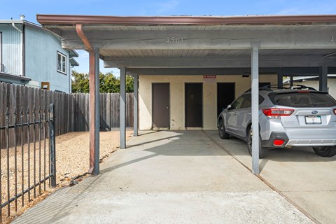 A car is parked in a garage with a sign that reads 45.01.