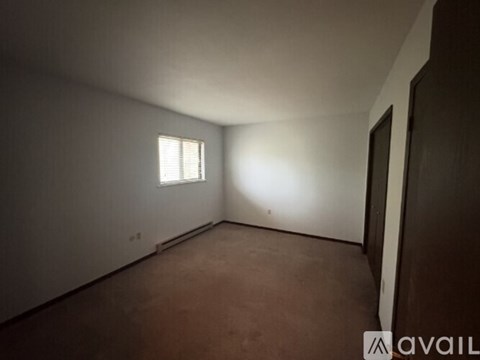 A room with a window and a door.