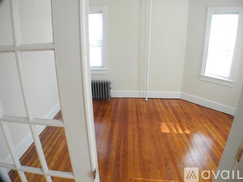 A room with wooden floors and white walls.