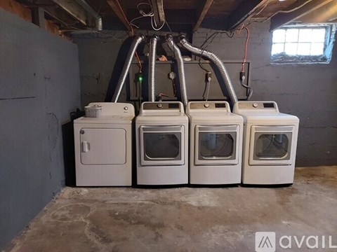 A row of white ovens are lined up in a room.