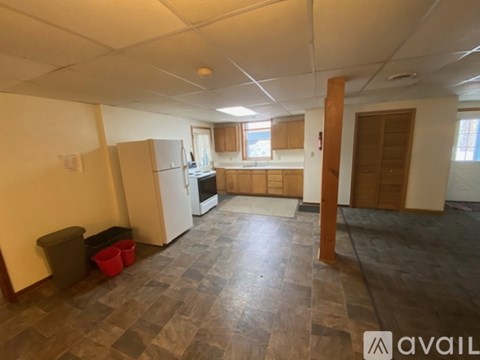 A kitchen area with a refrigerator, oven, and a countertop.