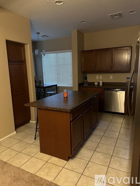 A kitchen with a brown countertop and a dishwasher.