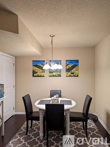 A dining room with a table and chairs.