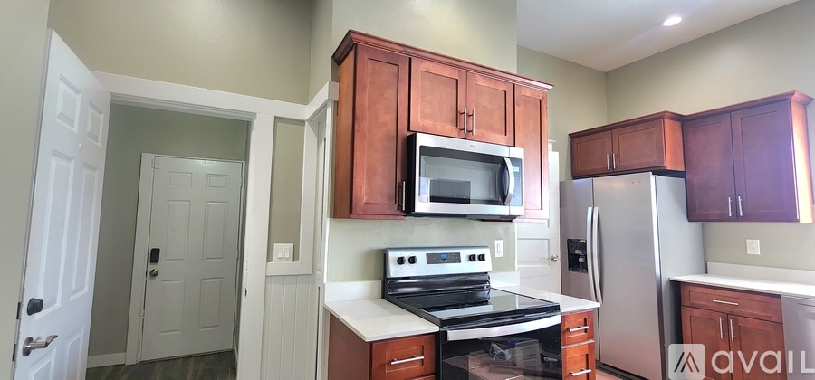 A kitchen with wooden cabinets and a stove top oven.