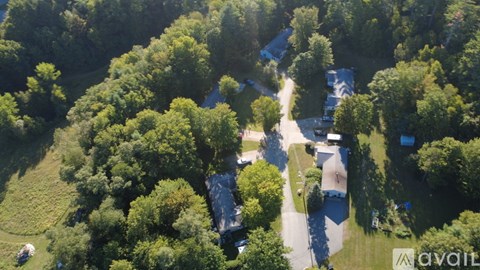 A bird's eye view of a residential area surrounded by trees.