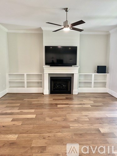 A living room with a fireplace and a television.