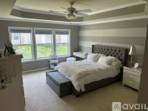 A bedroom with a large bed and a fireplace.