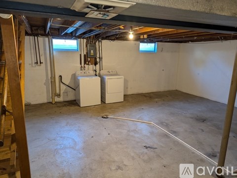 A room with a white tank and a white box on the floor.