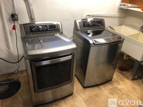 Two stainless steel ovens are in a kitchen.