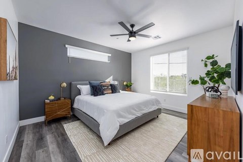 A bedroom with a bed, nightstand, and a television.