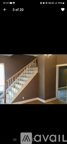 A staircase with white railings and a brown wall.