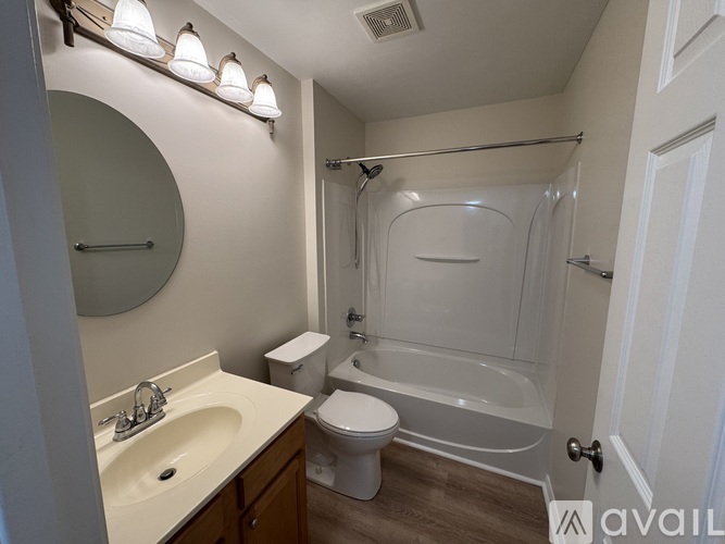 A bathroom with a toilet, sink, and bathtub.