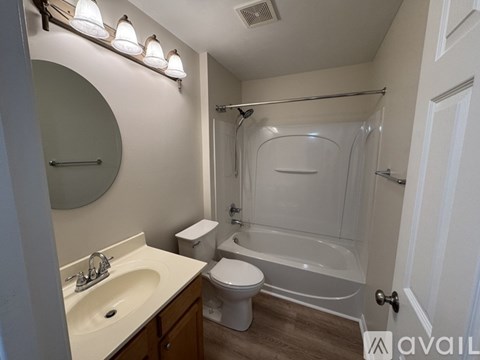 A bathroom with a toilet, sink, and bathtub.