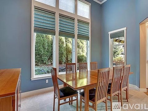 A dining room with a table and chairs.