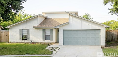 A white house with a grey garage door.