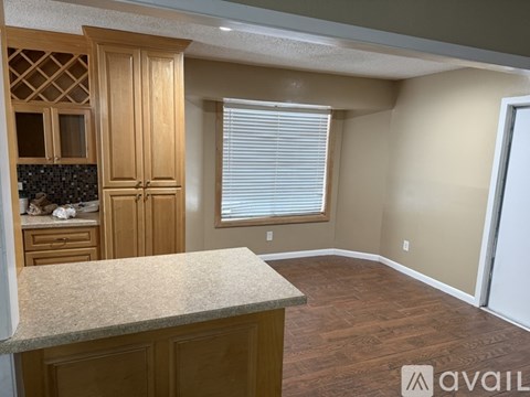 A kitchen with wooden cabinets and a granite countertop.