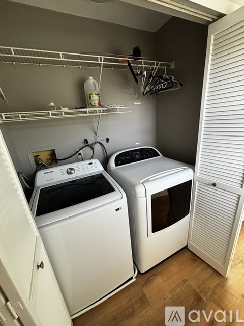 A small laundry room with a washer and dryer.