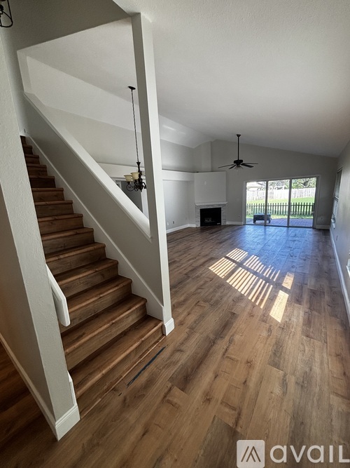 A living room with a staircase leading to the upper floor.