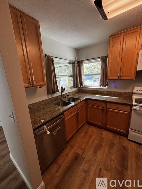 A kitchen with wooden cabinets and stainless steel appliances.