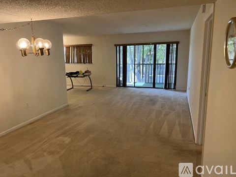 A living room with a dining table and chairs in the background.