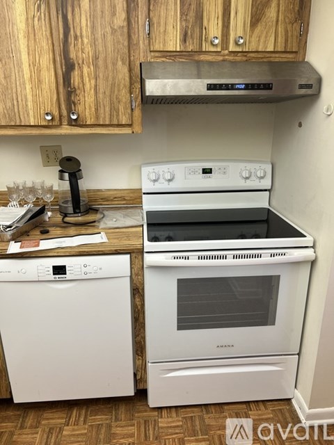 A white oven and dishwasher in a kitchen.