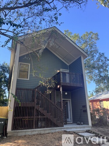 A house with a blue exterior and a wooden deck.