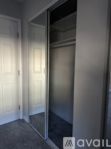 A room with a carpeted floor and a white door.
