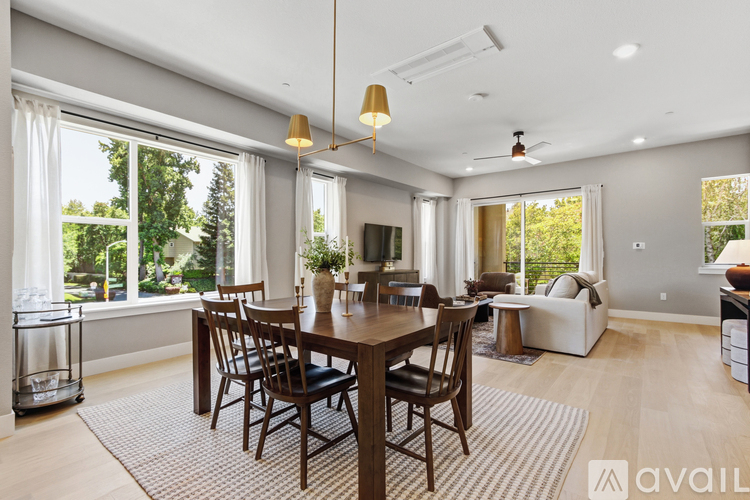 A dining room with a wooden table and chairs.
