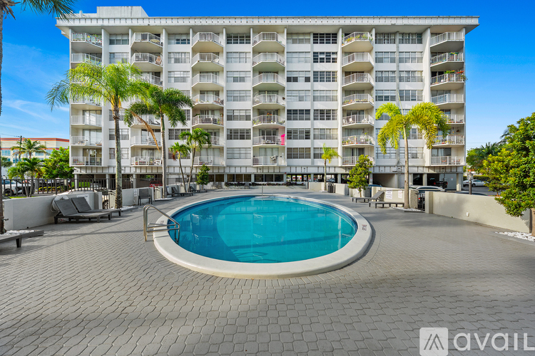 A large building with a pool in front.